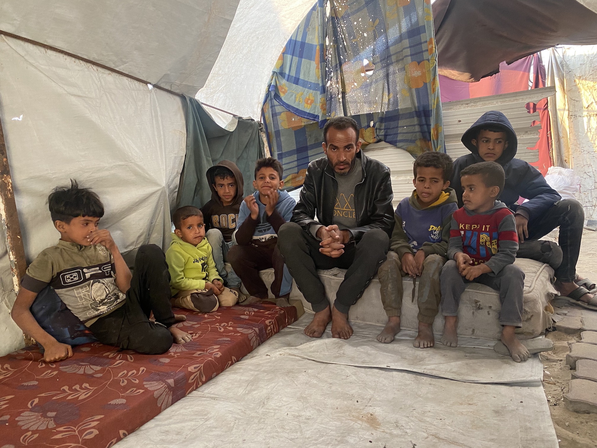 Ibrahim Badawi and his children, in the family’s tent in Gaza City, May 4, 2025. (Ahmed Ahmed)